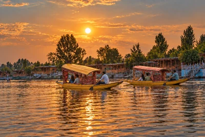 AI-enhanced scene of colourful covered Shikaras carrying passengers past Dal Lake houseboats at sunset